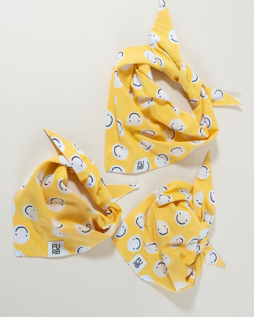 Yellow smiley face dog bandana, perfect for sunny days and joyful pups.