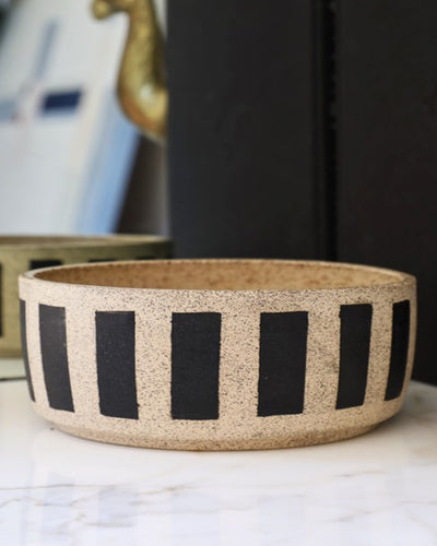 Each bowl is handmade with ceramic stonewear and striped, complete with a glaze to guarantee your pet eats and drinks safely. These bowls may vary in color and patinas, aging gracefully alongside your furry BFF.