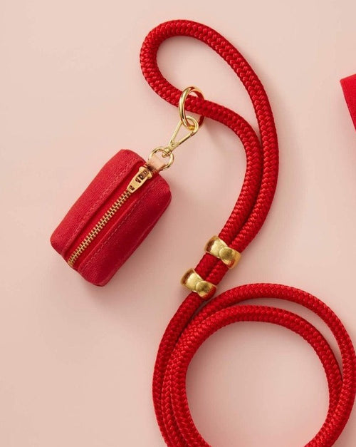 Functional red poop bag holder, a must-have accessory for every pet owner.