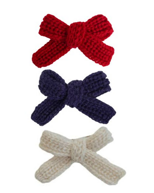 Close-up of patriotic Little Darling dog hair bow in red, white, and blue.