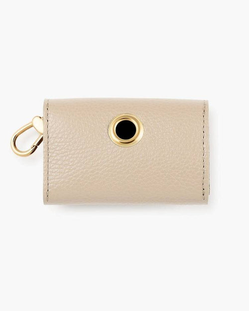 Compact ivory poop bag holder attached to leash, combining convenience and elegance