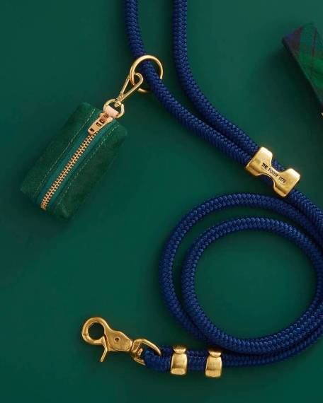 Waxed green cotton canvas is complete with elevated brass hardware. Sleek clasp easily attaches to your leash's O ring. There's no mess left behind with this adorable accessory.