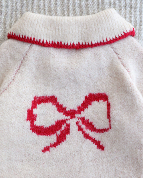 Holiday-inspired ivory bow sweater for dogs with soft knit fabric and colorful collar accents for small to medium breed dogs