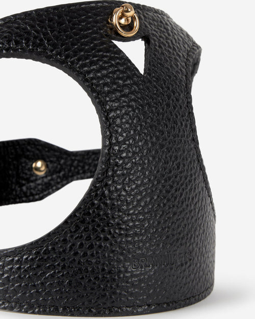 Close-up front of black leather dog harness showing design and premium materials